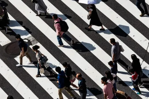 People walking over zebra crossing ryoji-iwata-people-black-whi