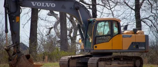 Photo by Jeremy Waterhouse: https://www.pexels.com/photo/yellow-and-black-excavator-on-green-field-near-leafless-trees-12063807/
