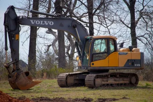 Photo by Jeremy Waterhouse: https://www.pexels.com/photo/yellow-and-black-excavator-on-green-field-near-leafless-trees-12063807/